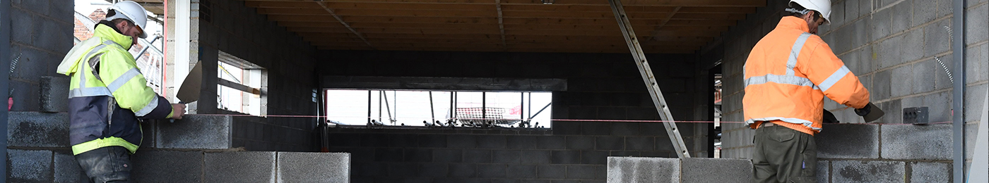 Two men building a wall CDM Construction
